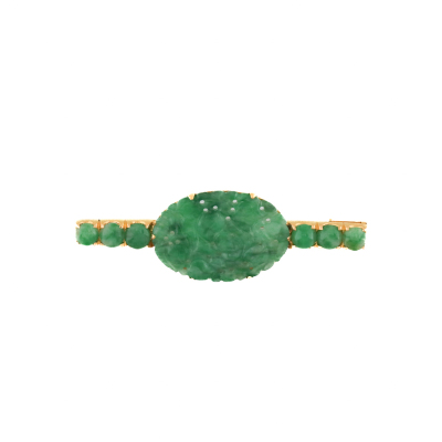 Carved Jade brooch set in yellow gold